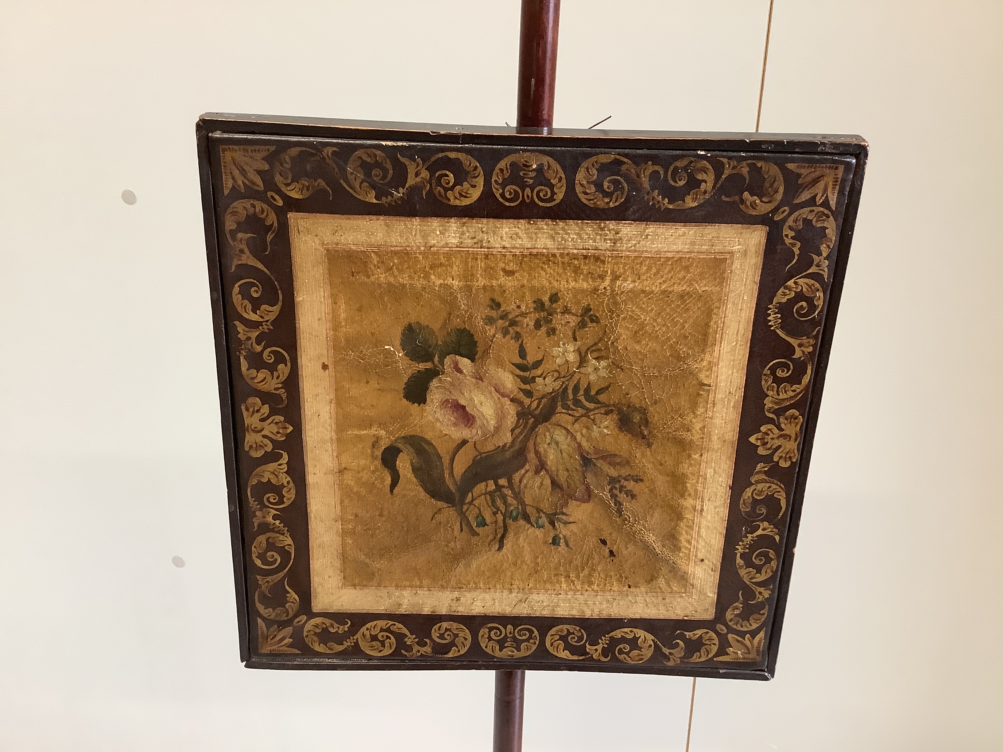 A George III mahogany polescreen with painted canvas panel, height 125cm